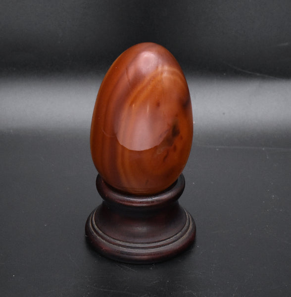 Carved Carnelian Egg on Wood Stand