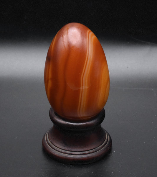 Carved Carnelian Egg on Wood Stand