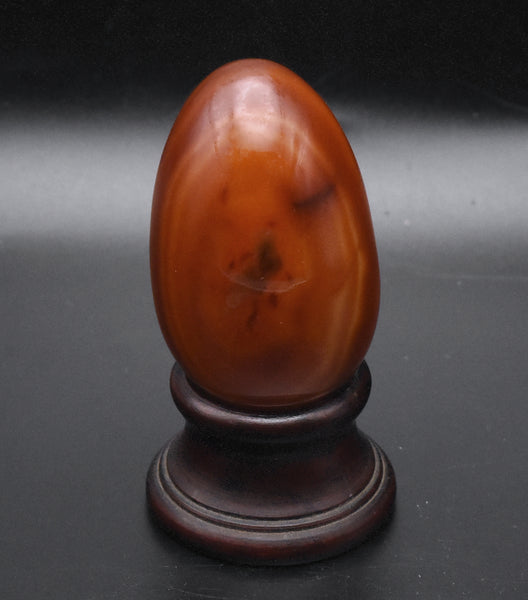 Carved Carnelian Egg on Wood Stand