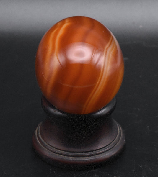 Carved Carnelian Egg on Wood Stand