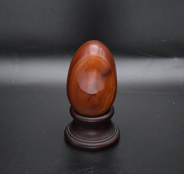 Carved Carnelian Egg on Wood Stand