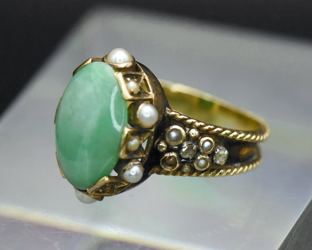 Gorgeous handmade vintage 18k gold ring, set with a lovely oval cabochon of jade, accented with bezel set pearls of various sizes, as well as rose cut diamonds.