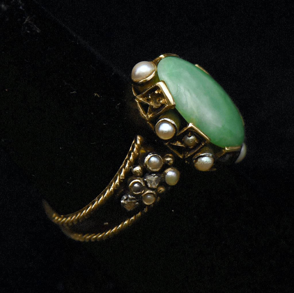 Gorgeous handmade vintage 18k gold ring, set with a lovely oval cabochon of jade, accented with bezel set pearls of various sizes, as well as rose cut diamonds.