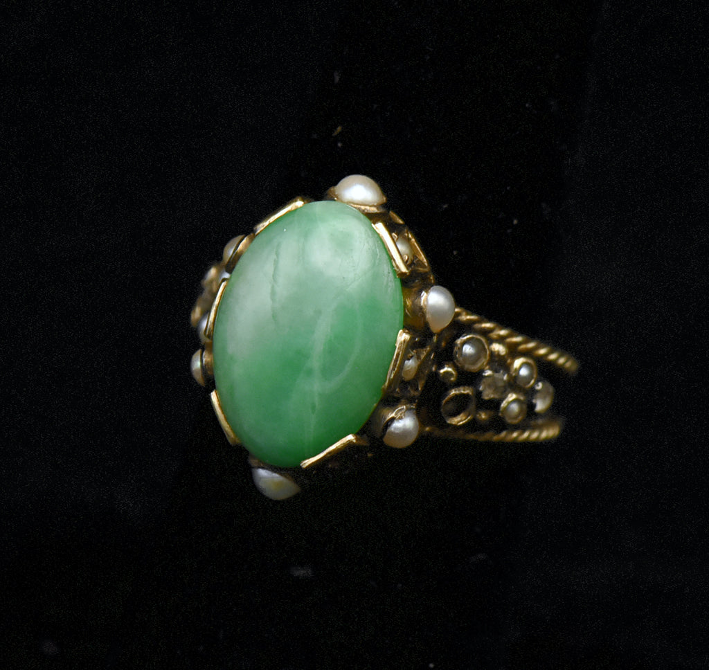 Gorgeous handmade vintage 18k gold ring, set with a lovely oval cabochon of jade, accented with bezel set pearls of various sizes, as well as rose cut diamonds.