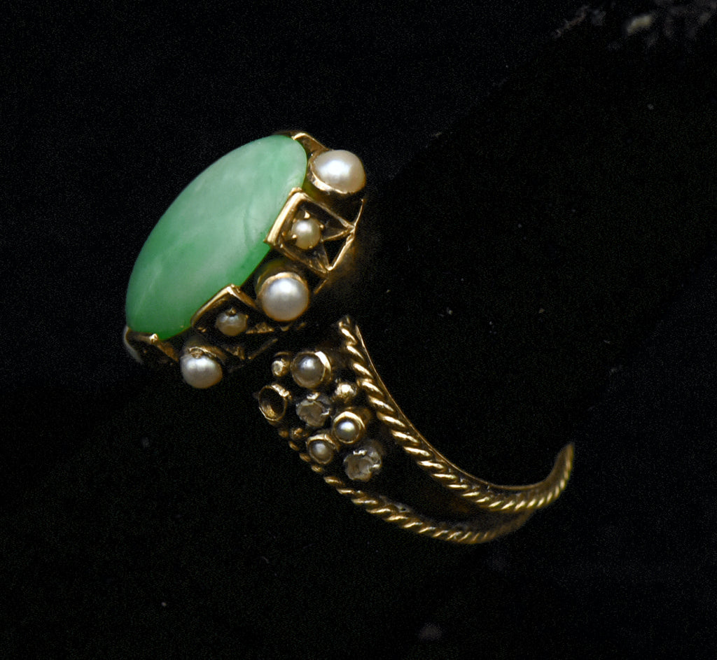 Gorgeous handmade vintage 18k gold ring, set with a lovely oval cabochon of jade, accented with bezel set pearls of various sizes, as well as rose cut diamonds.