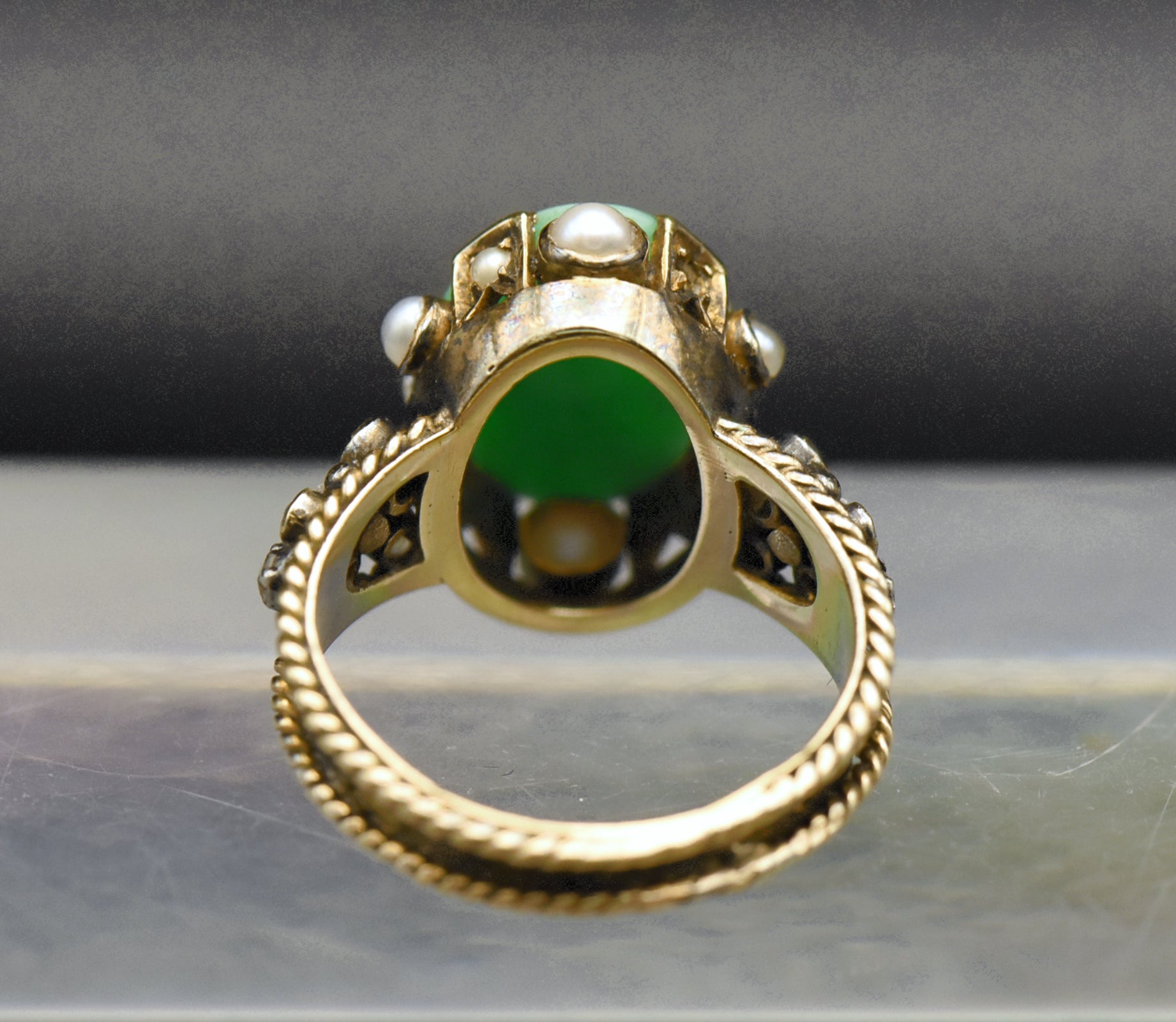 Gorgeous handmade vintage 18k gold ring, set with a lovely oval cabochon of jade, accented with bezel set pearls of various sizes, as well as rose cut diamonds.