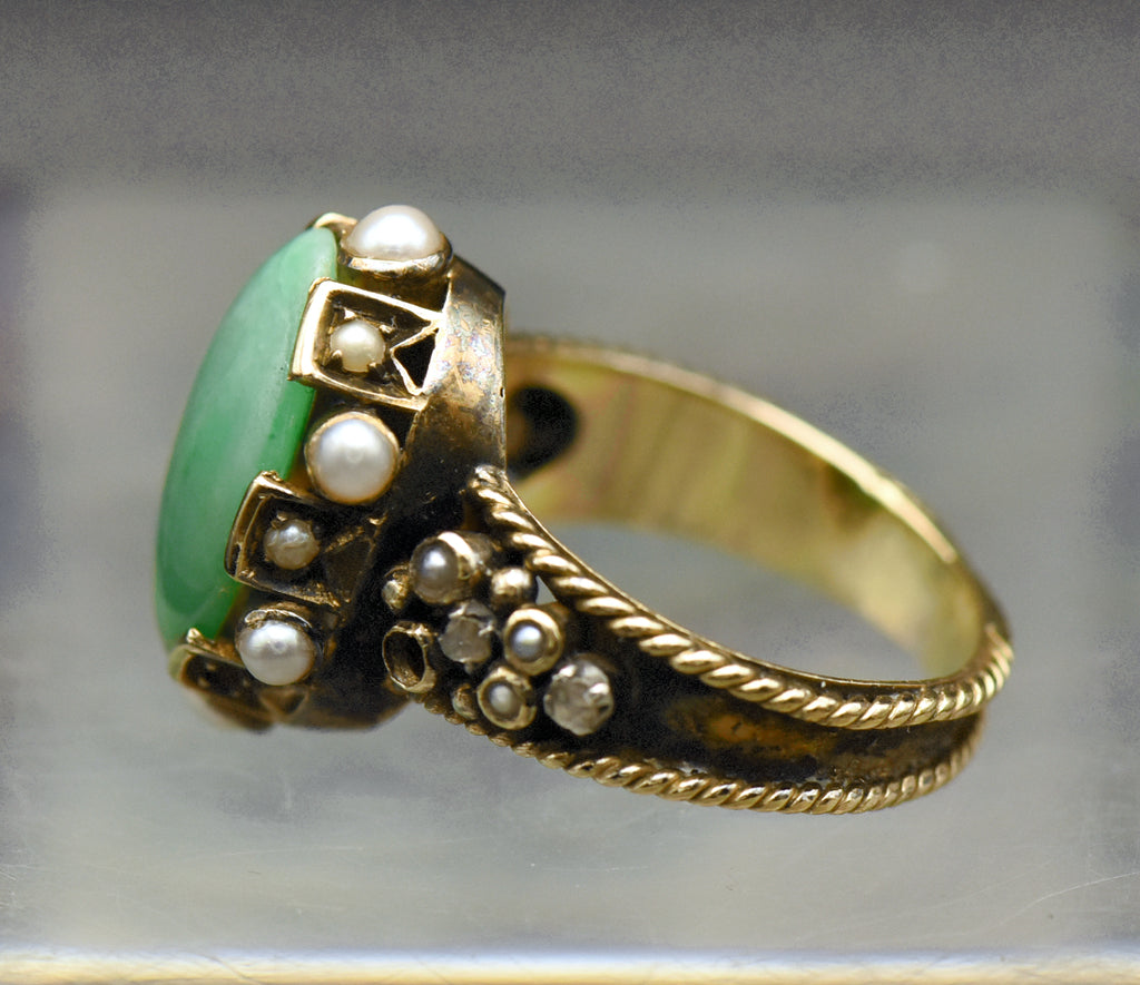 Gorgeous handmade vintage 18k gold ring, set with a lovely oval cabochon of jade, accented with bezel set pearls of various sizes, as well as rose cut diamonds.