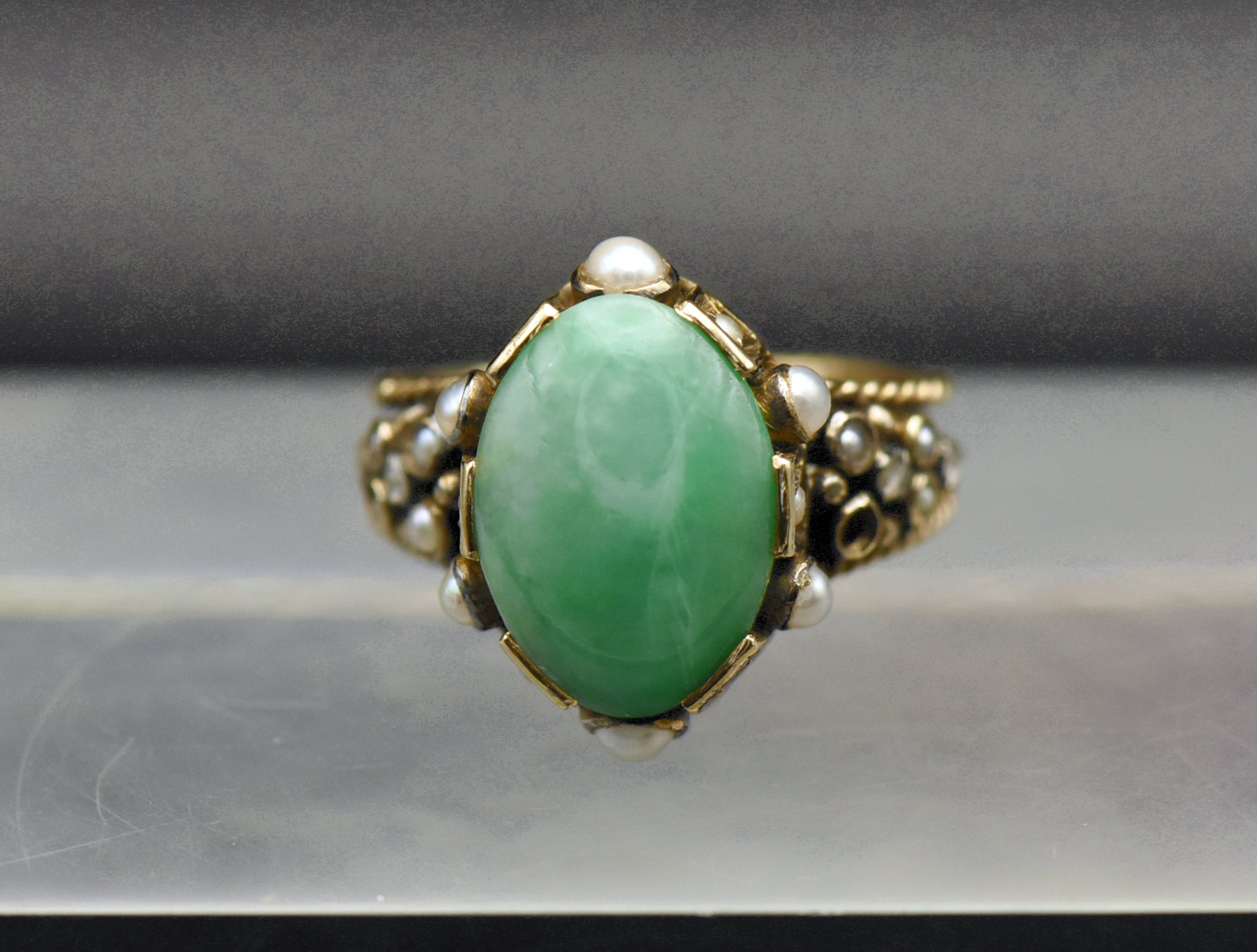 Gorgeous handmade vintage 18k gold ring, set with a lovely oval cabochon of jade, accented with bezel set pearls of various sizes, as well as rose cut diamonds.