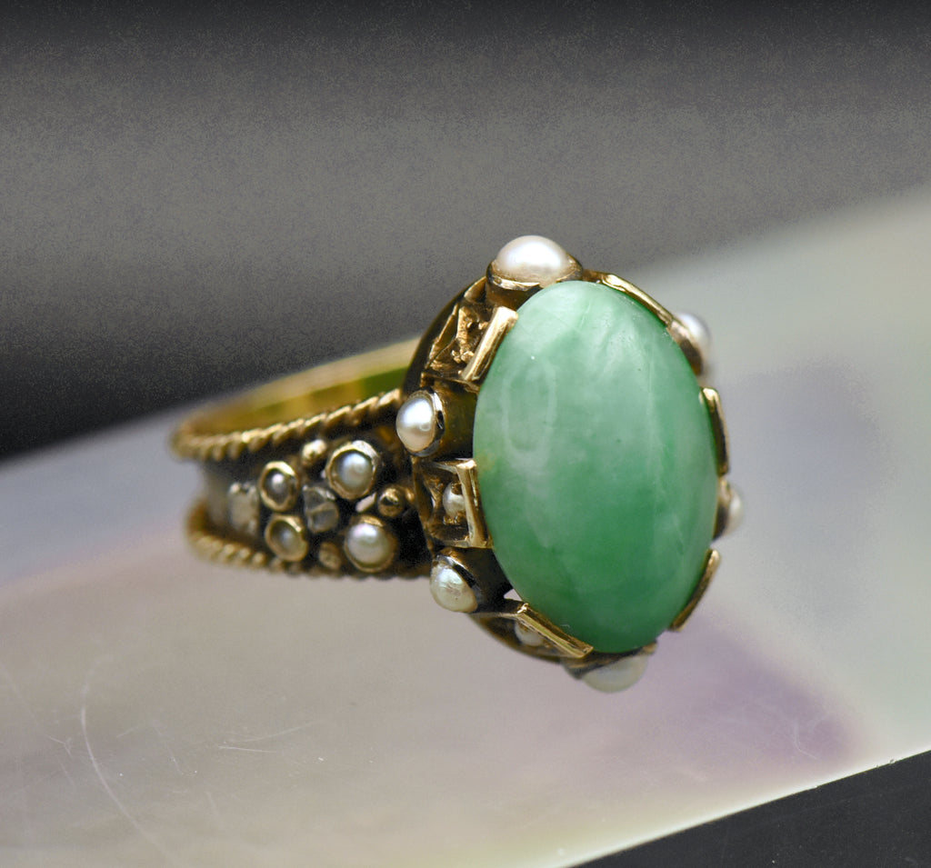 Gorgeous handmade vintage 18k gold ring, set with a lovely oval cabochon of jade, accented with bezel set pearls of various sizes, as well as rose cut diamonds.