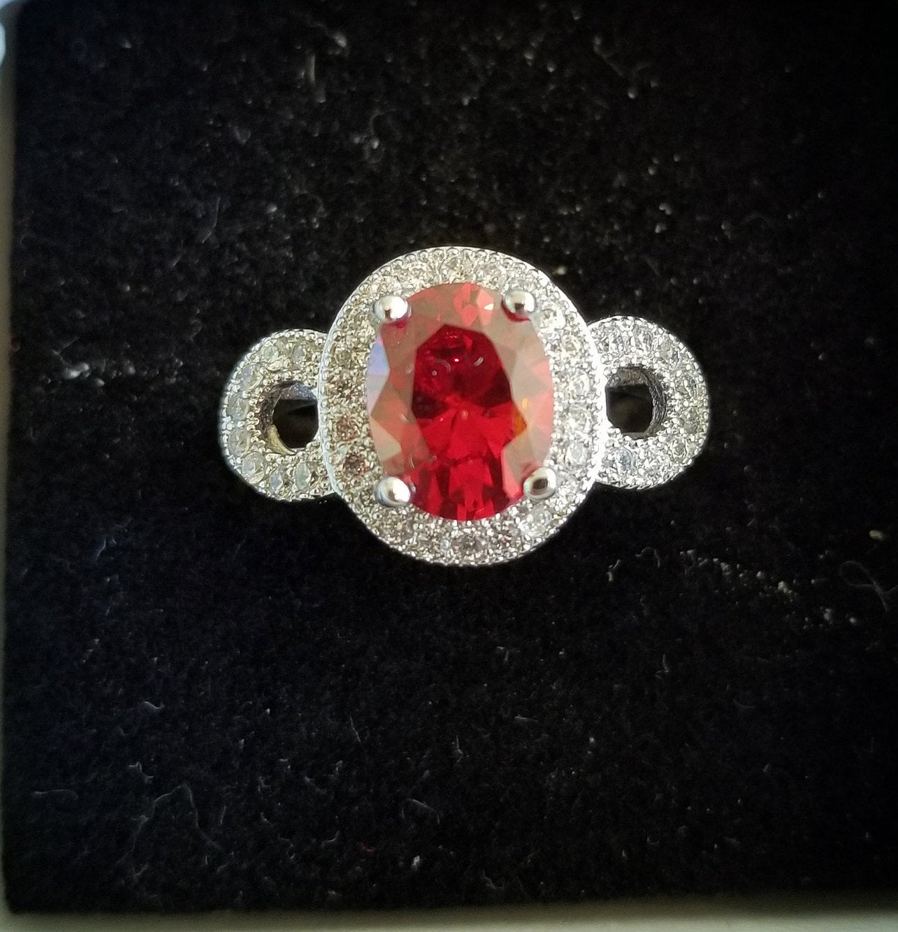 Sterling Silver Ring with Oval Cut Simulated Ruby and Simulated Diamonds