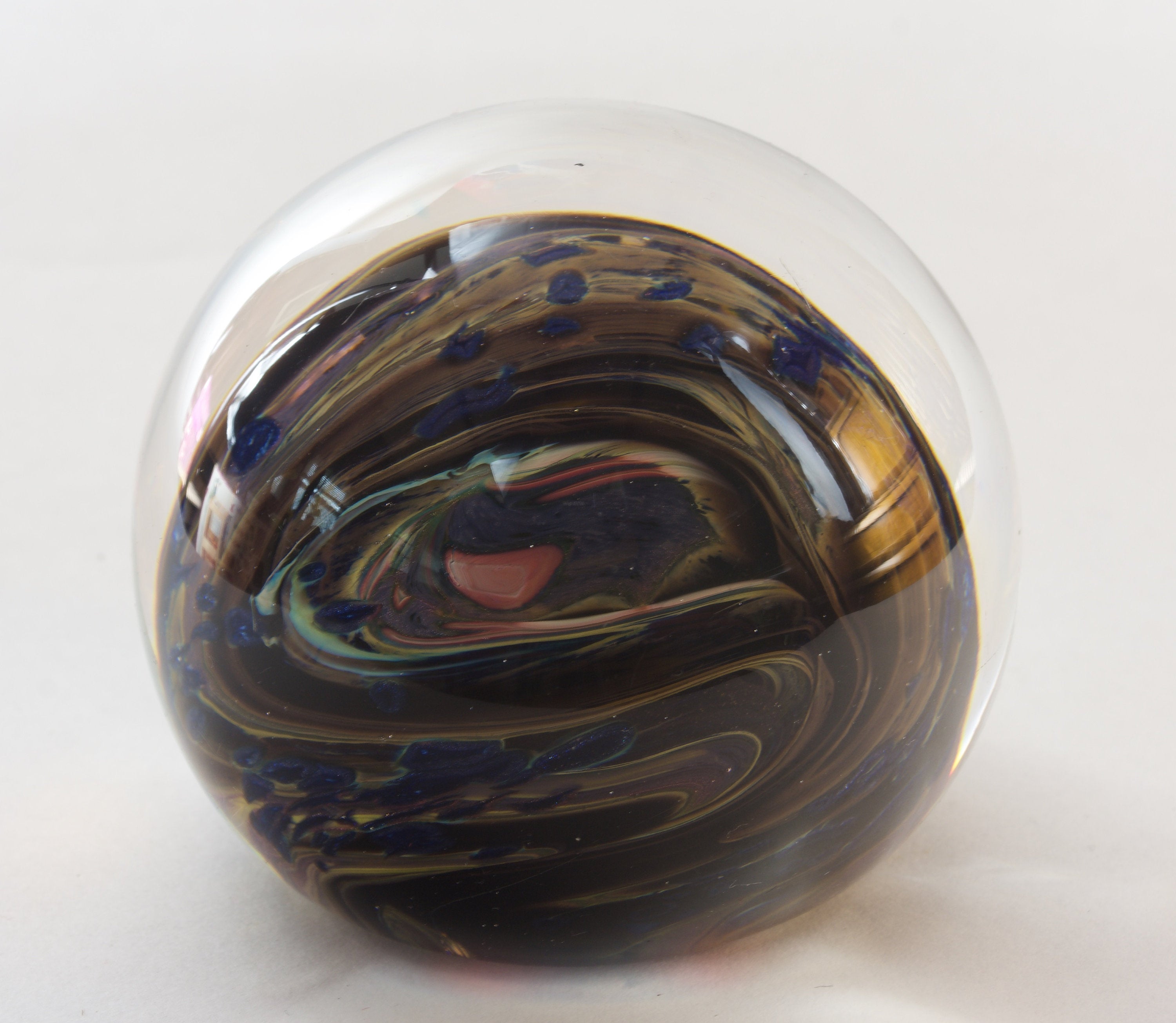 Brown, Yellow, Sparkly Blue and More In this Swirling Glass Paperweight