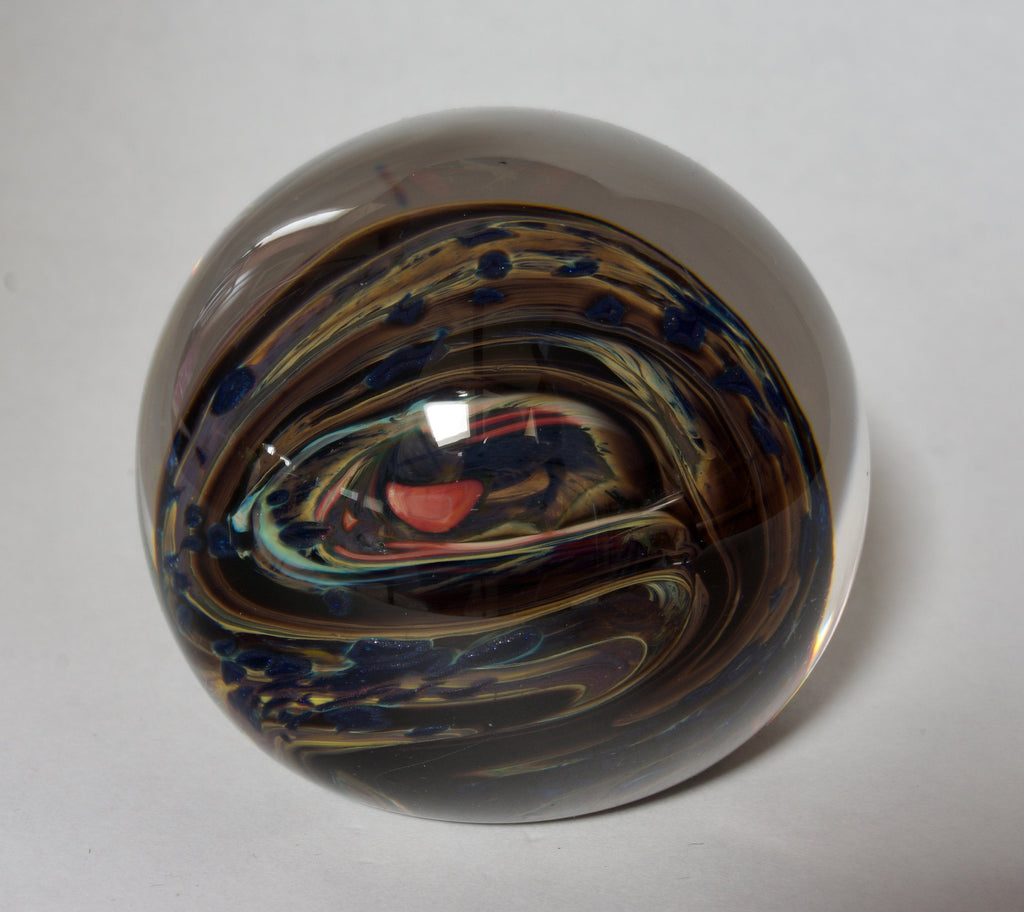 Brown, Yellow, Sparkly Blue and More In this Swirling Glass Paperweight