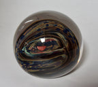 Brown, Yellow, Sparkly Blue and More In this Swirling Glass Paperweight