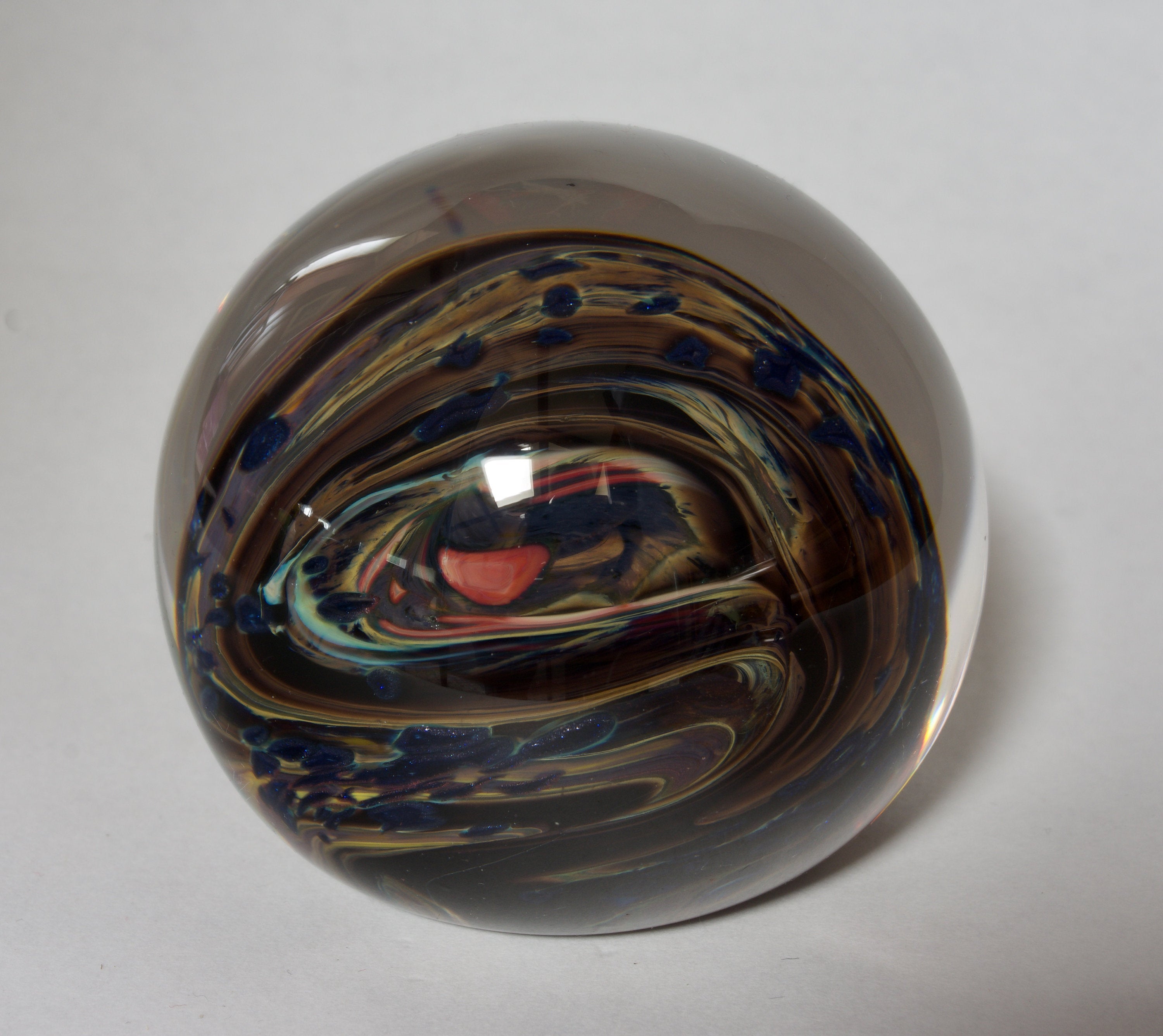 Brown, Yellow, Sparkly Blue and More In this Swirling Glass Paperweight