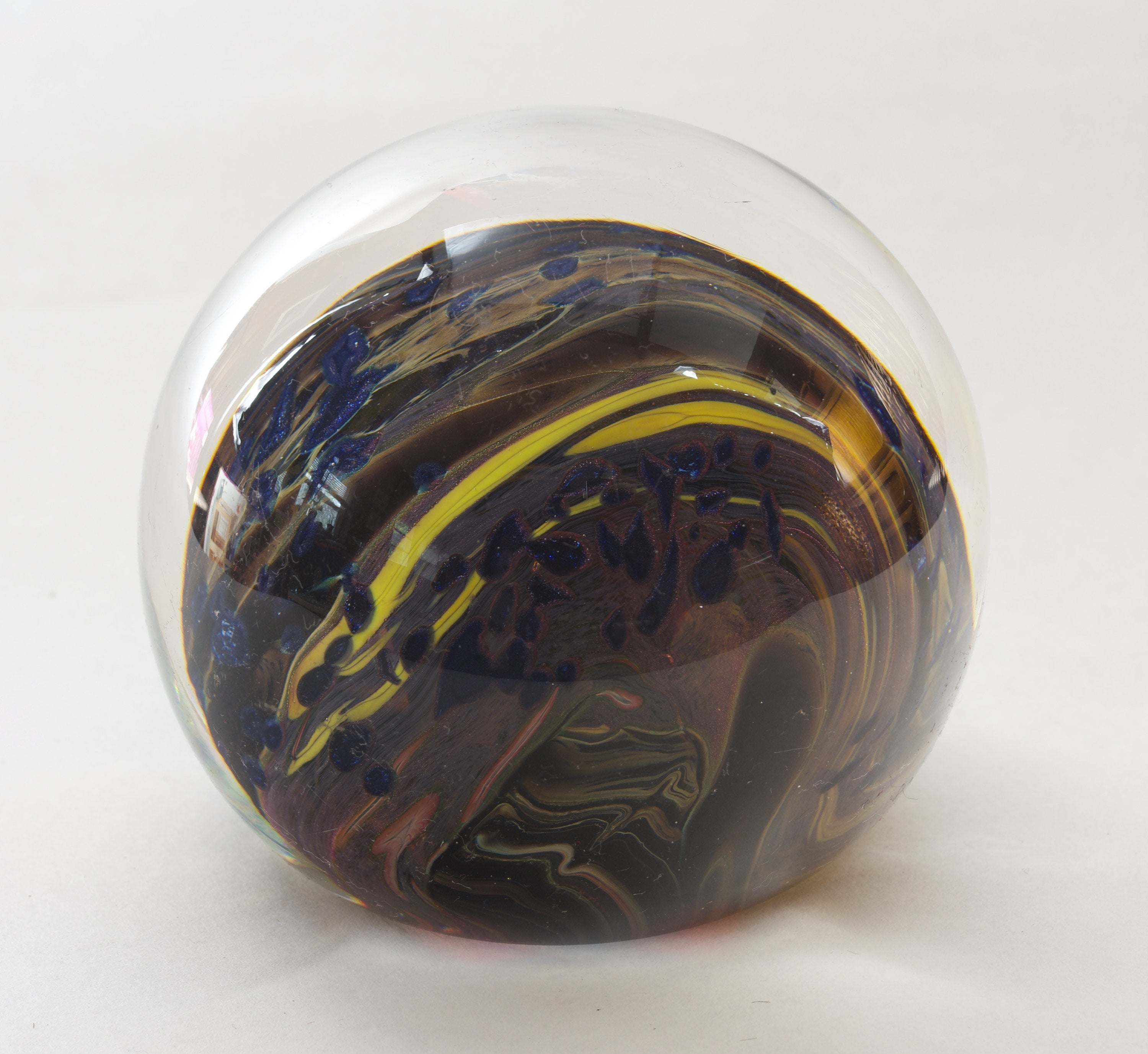 Brown, Yellow, Sparkly Blue and More In this Swirling Glass Paperweight